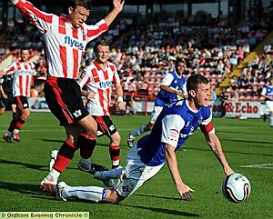 COME ON REF! Zander Diamond was felled in the panalty area — but no penalty. 