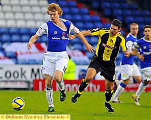 GETTING SHIRTY: Burton’s Andy Corbett adopts unfair means to try to keep Chris Taylor in check. Pictures by Lee Dickenson 