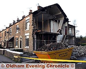 DEATH trap . . . the house was left dangerously exposed last week after scaffolding and stonework collapsed. 

