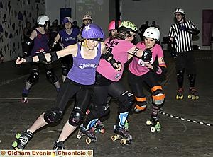 OUT OF MY WAY: Randi Razorlegs (left), of Rainy City Roller Girls, breaks through. 