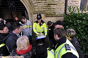 Police briefing . . . investigators go through the procedure 
