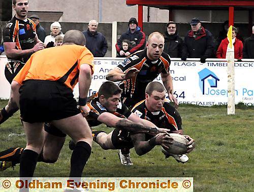 FIRST TO THE BALL. . . Ben Wood gets both hands on the prize to register Oldham’s first try of their Law Cup victory over Rochdale Hornets. PICTURE: CHRIS SUNDERLAND