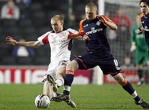 ACTION MAN . . . Sam Mantom wins the ball off midfield rival Luke Chadwick. 