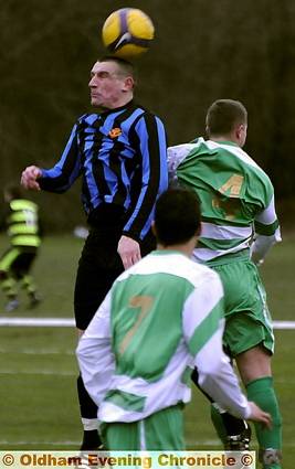 LEE O’Brien, of Avro, beats Springhead’s Dale Jackman to the ball during the leaders’ 3-1 victory. Avro are now one point ahead of second-placed Manchester Gregorians in the Manchester League Premier Division table, with a game in hand. 
