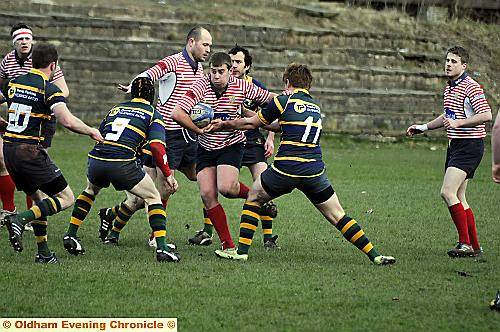 COMING THROUGH . . . Oldham hooker Jake Watson looks for a gap in the Keswick line. 