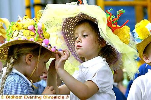 IS MY hat straight? Lily Boardman makes sure Katie Reid’s Easter bonnet is in perfect position for the parade at St Mary’s School in Failsworth.  

