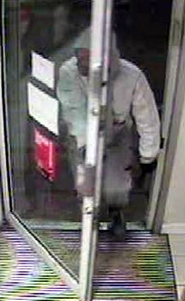 CAUGHT on camera . . . one of the robbers enters the petrol station in Shaw Road 