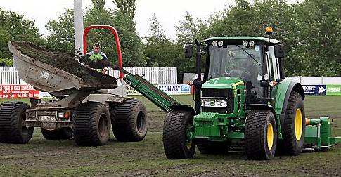 TRACTOR BOYS... work is carried out on the Oldham playing surface. TRACTOR BOYS... work is carried out on the Oldham playing surface.