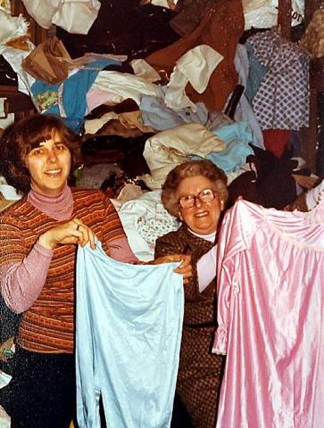 MOUNTAIN of clothes... Mary Pendlebury, left, in 1980 at Oxfam in Oldham 