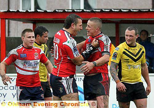 STAR man Jamie Dallimore is grabbed by Dave Ellison after scoring one of his two tries in Oldham’s defeat of South Wales Scorpions. 