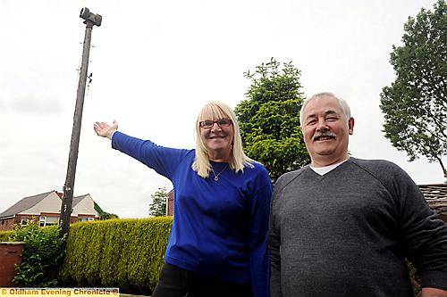 SIREN call . . . Mary and Tommy McGann with the Second World War siren that towers above their Royton garden 