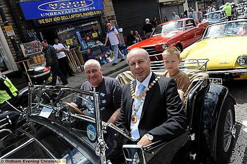 HITCHING A RIDE: Glen Hilditch in his 1955 MG offers a lift to Alexander Newton Hall and John Hall, Chair of Shaw and Crompton Parish council. 
