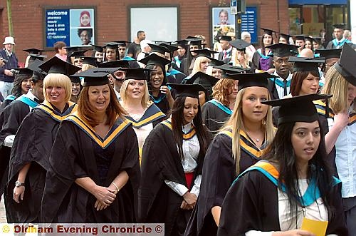 SEA OF SMILES . . . proud graduates, happy to see the sun shining as they joined the procession around the town centre prior to receiving their degrees at yesterday’s Queen Elizabeth Hall ceremony. 