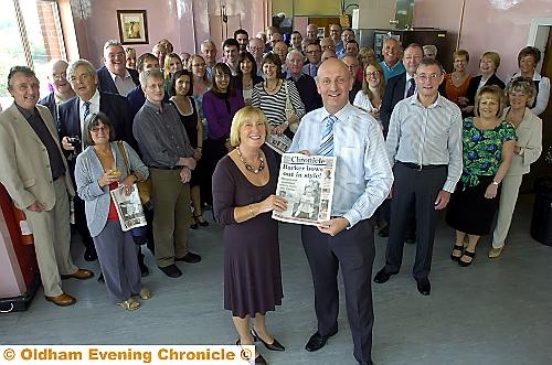 HERE IS THE NEWS... Janice Barker’s retirement literally was stop-press news yesterday when the Trinity presses at Hollinwood rolled to produce a special souvenir edition to mark her 35 years at the Chronicle. Janice is pictured receiving a copy of the “Barker bows out in style” edition from Editor David Whaley watched by current and former colleagues, councillors, guests and family. 

