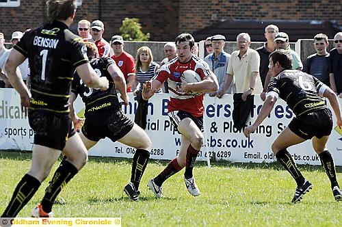BREAKING through . . . Mark McCully looks for a gap in the Whitehaven line as Oldham spring forward. 
