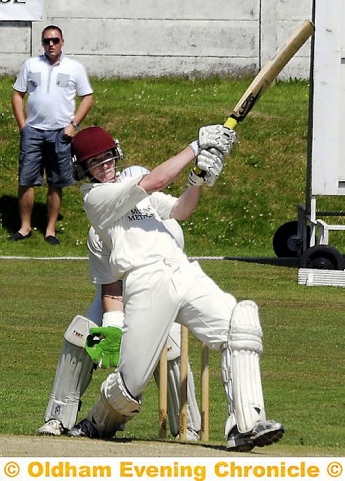 smashing time... Royton batsman Ryan Carruthers hits a four on his way to 48 in the semi-final showdown. 
