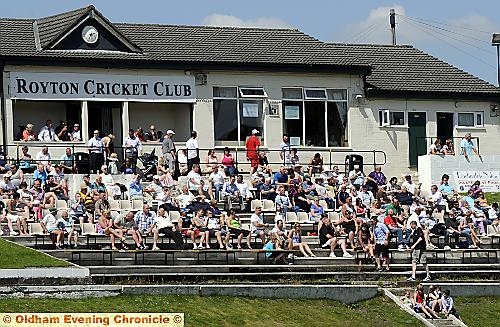 SOAKING UP THE SUN . . . cricket watchers follow the action in the Wood Cup semi-final at the Paddock. Picture by CHRIS SUNDERLAND 