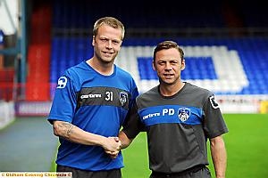 PAUL DICKOV welcomes Nathan Clarke to Boundary Park above. 