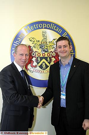 SHAKE on it... Latics chairman Simon Corney, left, and council leader Jim McMahon 
