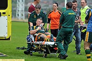 AGONY: Oldham St Anne’s star Luke Wallace receives treatment after breaking his leg. 