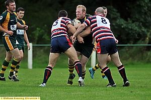 IN THE THICK OF IT: John Fox, of Oldham St Anne’s, is stopped in his tracks by two Normanton Knights opponents. 
