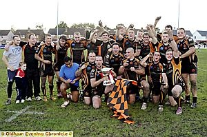 Oldham players and coaching staff celebrate grand final victory over Widnes.
Oldham players and coaching staff celebrate grand final victory over Widnes.