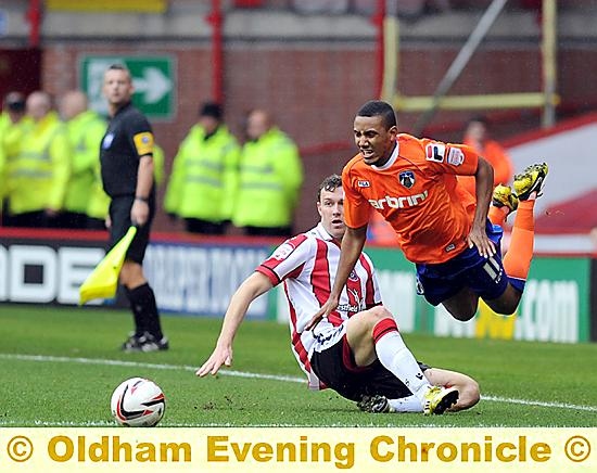 OUCH . . . Athletic winger Cristian Montano feels the force of a strong challenge. 