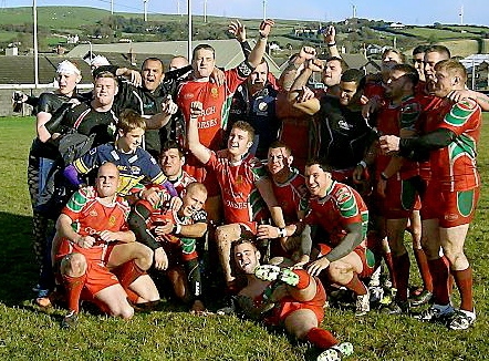 PARTY TIME: Waterhead players, coaches and fans celebrate promotion after victory at Askam. PARTY TIME: Waterhead players, coaches and fans celebrate promotion after victory at Askam.