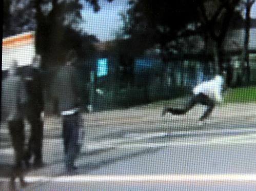 SHOPPERS look on as the hooded man gets up, falls twice and finally runs off. 
