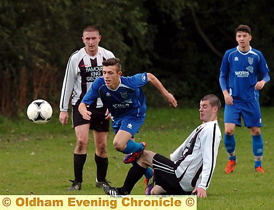 HEADING FOR A FALL: Neil Hindley, of Famous King George, slides in to challenge Failsworth Athletic’s Niall Sultan.
HEADING FOR A FALL: Neil Hindley, of Famous King George, slides in to challenge Failsworth Athletic’s Niall Sultan.