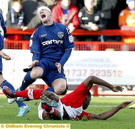 IN THE WARS . . . Robbie Simpson, already sporting a head wound, is felled by the tackle which led to Hope Akpan’s dismissal. 