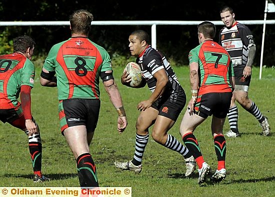 SURROUNDED . . . Junior Brandford, of Saddleworth Rangers, tries to find a way through the Myton Warriors line in the Premier Division clash. 