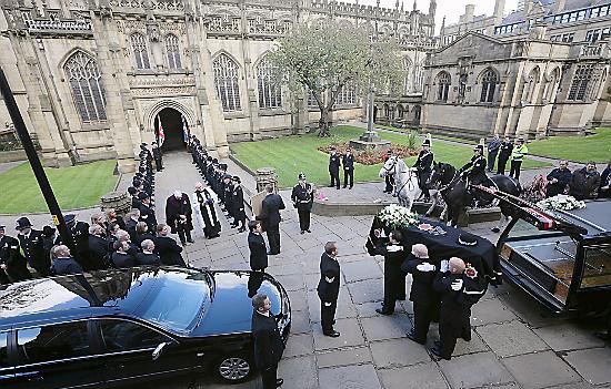 The coffin of Pc Hughes is carried into Manchester Cathedral. 
