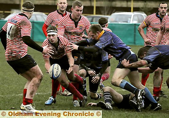 OVER TO YOU . . . Jack Taylor finds a team-mate from a ruck as Oldham look to find a way through the Garstang line. 