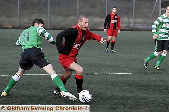 LET’S GO: Hollinwood's Lewis Green sidesteps a Salford Victoria opponent. 