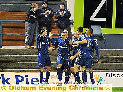 GIVE THEM A CLAP... three Athletic fans join in the celebrations after their side’s third goal, courtesy of Matt Derbyshire (left), against Doncaster. 