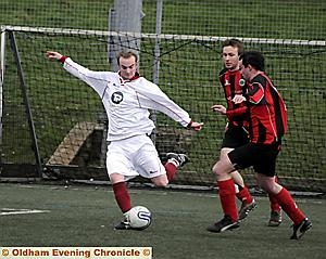 ON THE BALL . . . Danny Cashin (left), of Heyside, takes a swing as Heywood's Sean O'Connor closes him down during the Huddersfield and District League Division Two clash. ON THE BALL . . . Danny Cashin (left), of Heyside, takes a swing as Heywood's Sean O'Connor closes him down during the Huddersfield and District League Division Two clash.