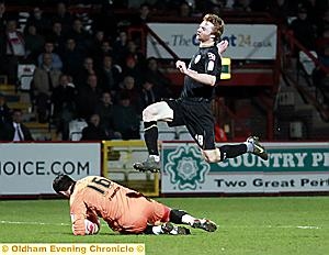 Forward Chris Taylor is beaten to the ball by his former Athletic teammate Chris Day. 