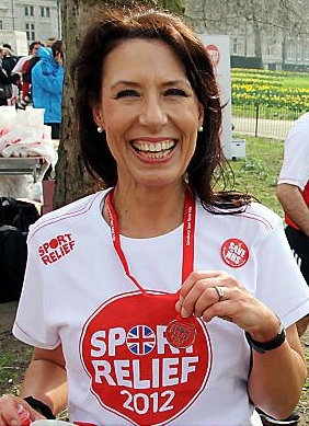 DEBBIE gets a medal for her effort in the Westminster Mile, which saw her cross the line in 7m 5s 
