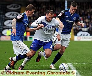 ACTION MAN . . . Shefki Kuqi takes on two Rochdale defenders. 