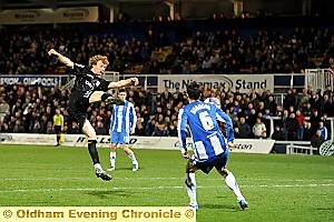TAKE TO THE AIR . . . Chris Taylor leaps from the ground to volley a shot at the Hartlepool goal.  