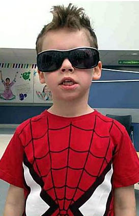 AFTER . . . Hector with short hair and Spider-Man outfit  

