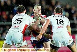 NOWHERE TO GO: Oldham’s Alex Thompson runs into St Helens pair Carl Forster (left) and Shaun Magennis. NOWHERE TO GO: Oldham’s Alex Thompson runs into St Helens pair Carl Forster (left) and Shaun Magennis.