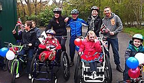 ON their bikes . . . Rhiain Harris-Larkin (back left) and Joanne McAllister (back, second right) with Huan and Megan (front) and supporters at the sponsored cycle ride 
