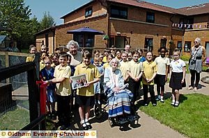 Fitting tribute: Max Durston and Lois Winterbottom from Watersheddings Primary School hold a picture of best friends Annie Walsh and Ivy Turner as they officially open the chicken-run tribute. Fitting tribute: Max Durston and Lois Winterbottom from Watersheddings Primary School hold a picture of best friends Annie Walsh and Ivy Turner as they officially open the chicken-run tribute.