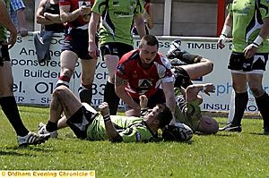 FLATOUT: Michael Ward touches down Oldham’s third try on a sweltering afternoon at Whitebank. 