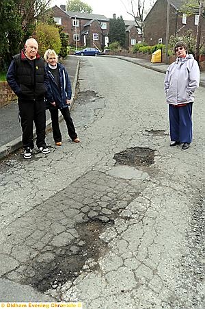 A HOLE lot of trouble . . . residents Raymond and Hilary Jones and Norma Race show the state of the road
A HOLE lot of trouble . . . residents Raymond and Hilary Jones and Norma Race show the state of the road