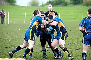 STUCK IN THE MIDDLE: Jack Hughes of Higginshaw charges into a trio of Ulverston players. STUCK IN THE MIDDLE: Jack Hughes of Higginshaw charges into a trio of Ulverston players.