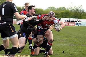 UP FOR THE BATTLE: Chris Clarke tries to beat the tackles for Oldham. UP FOR THE BATTLE: Chris Clarke tries to beat the tackles for Oldham.