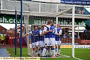 WELL DONE, MATE: James Tarkowski is congratulated by his Athletic team-mates after opening the scoring. 